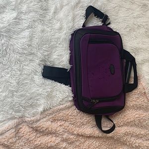Purple U.S Traveler cross body mini bag.